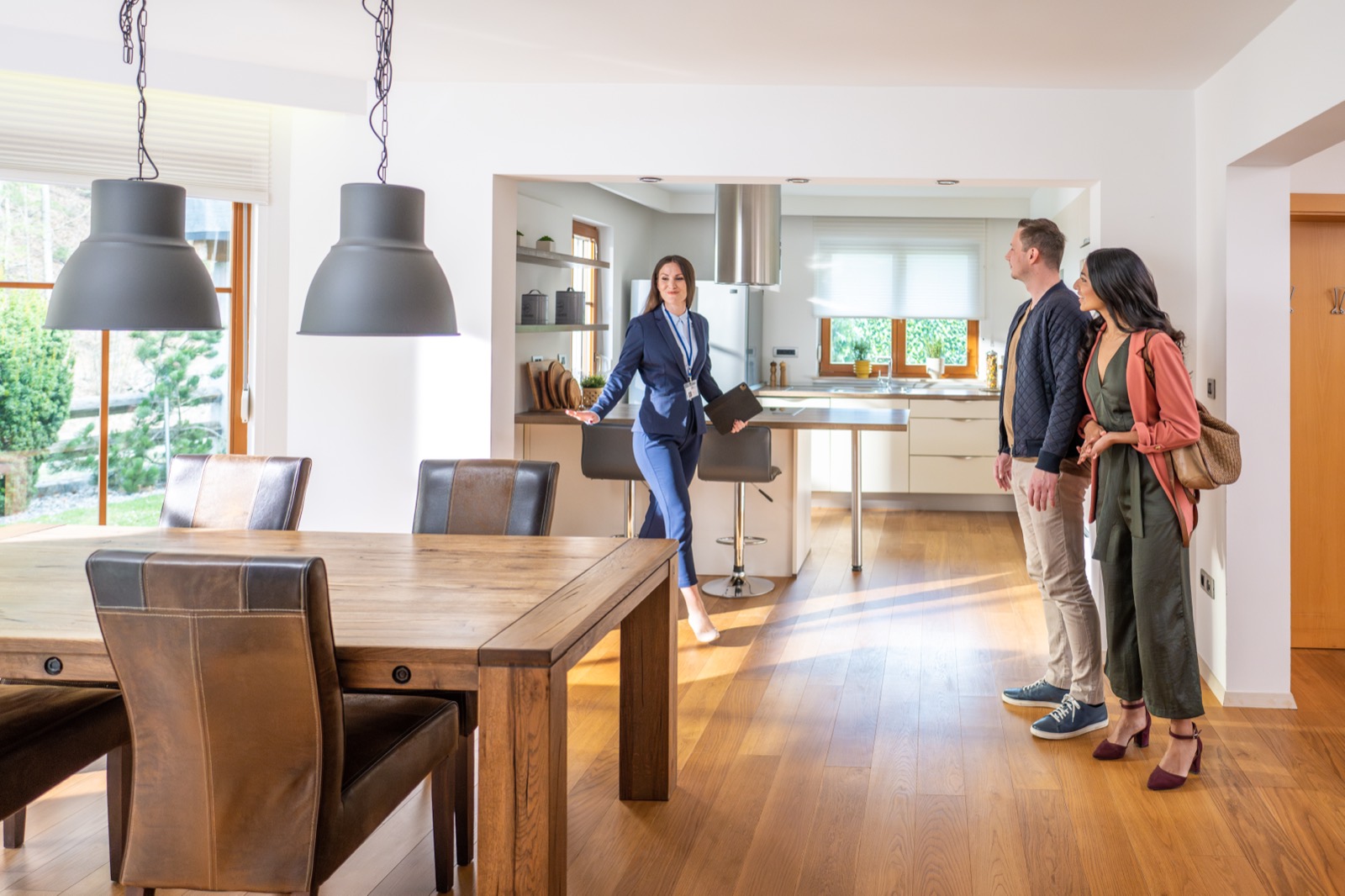 A real estate agent showing a home to a couple.